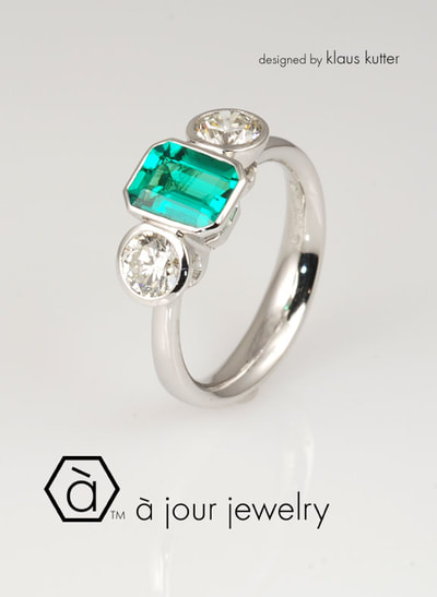 Modern emerald - diamond engagement ring 19K white gold